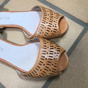 Butterscotch faux leather slip on shoes.